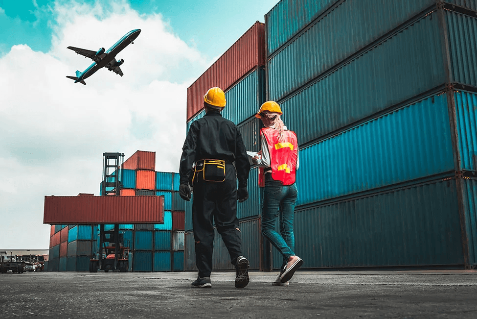 Workers looking at shipping containers